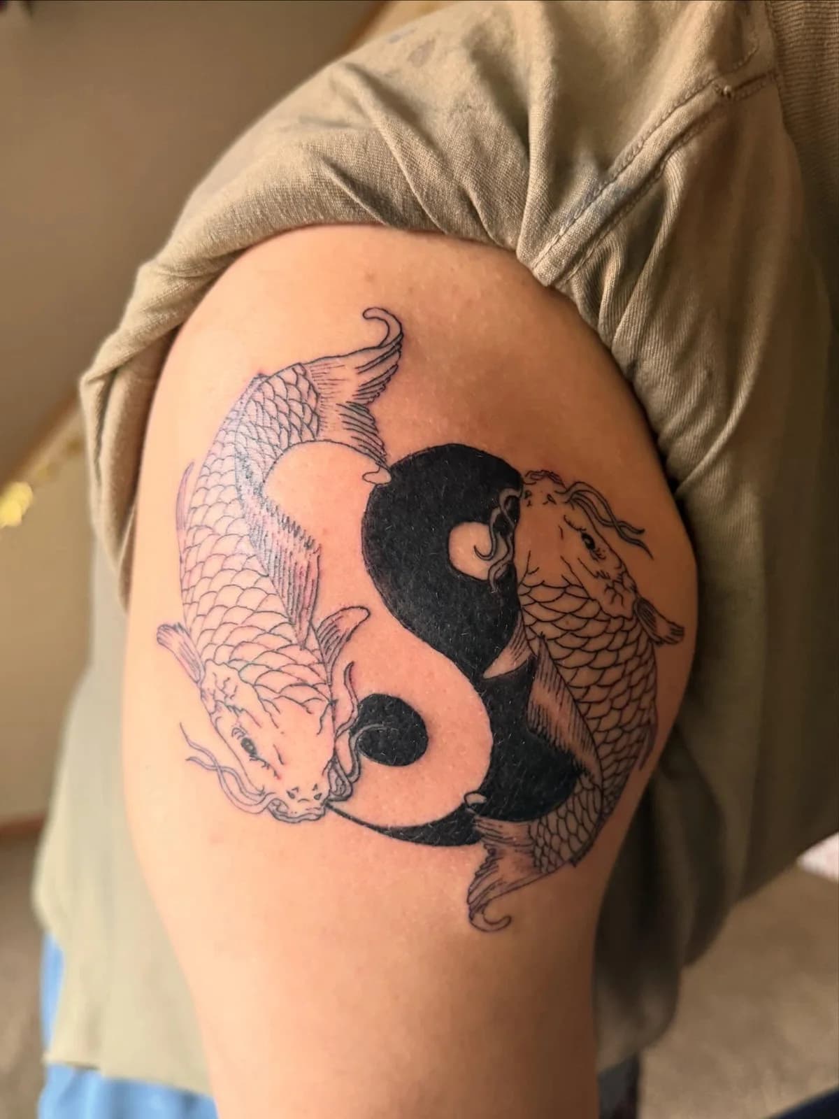 Two koi fish forming a yin-yang tattoo