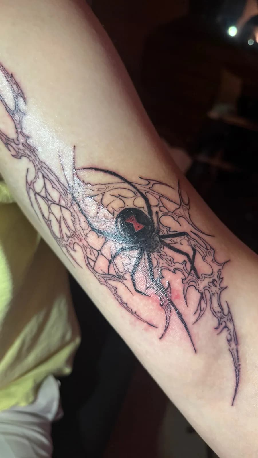 A fine-line spider tattoo by Bad Kid Ink
